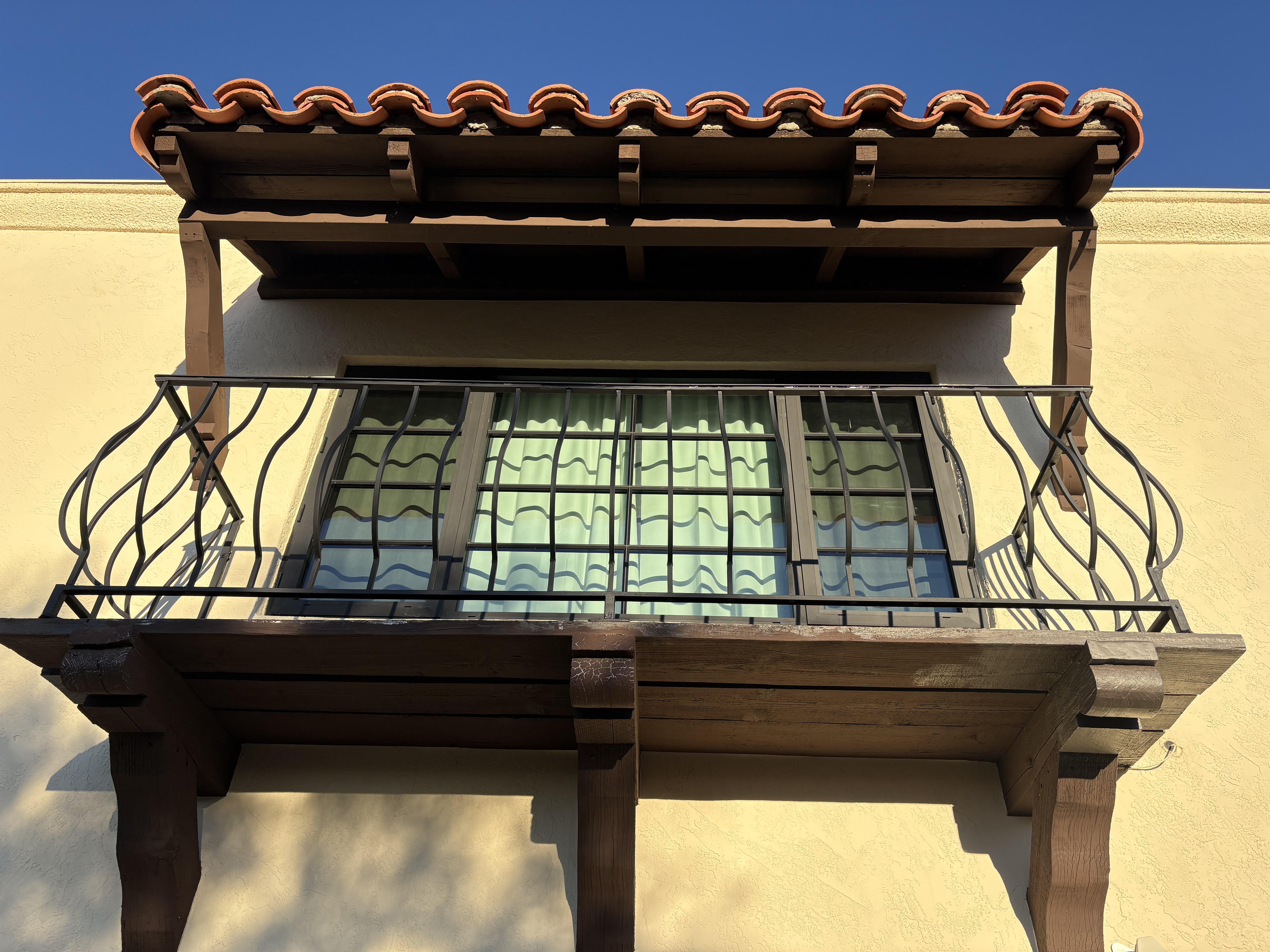Decorative iron balcony railing with terracotta tile roof