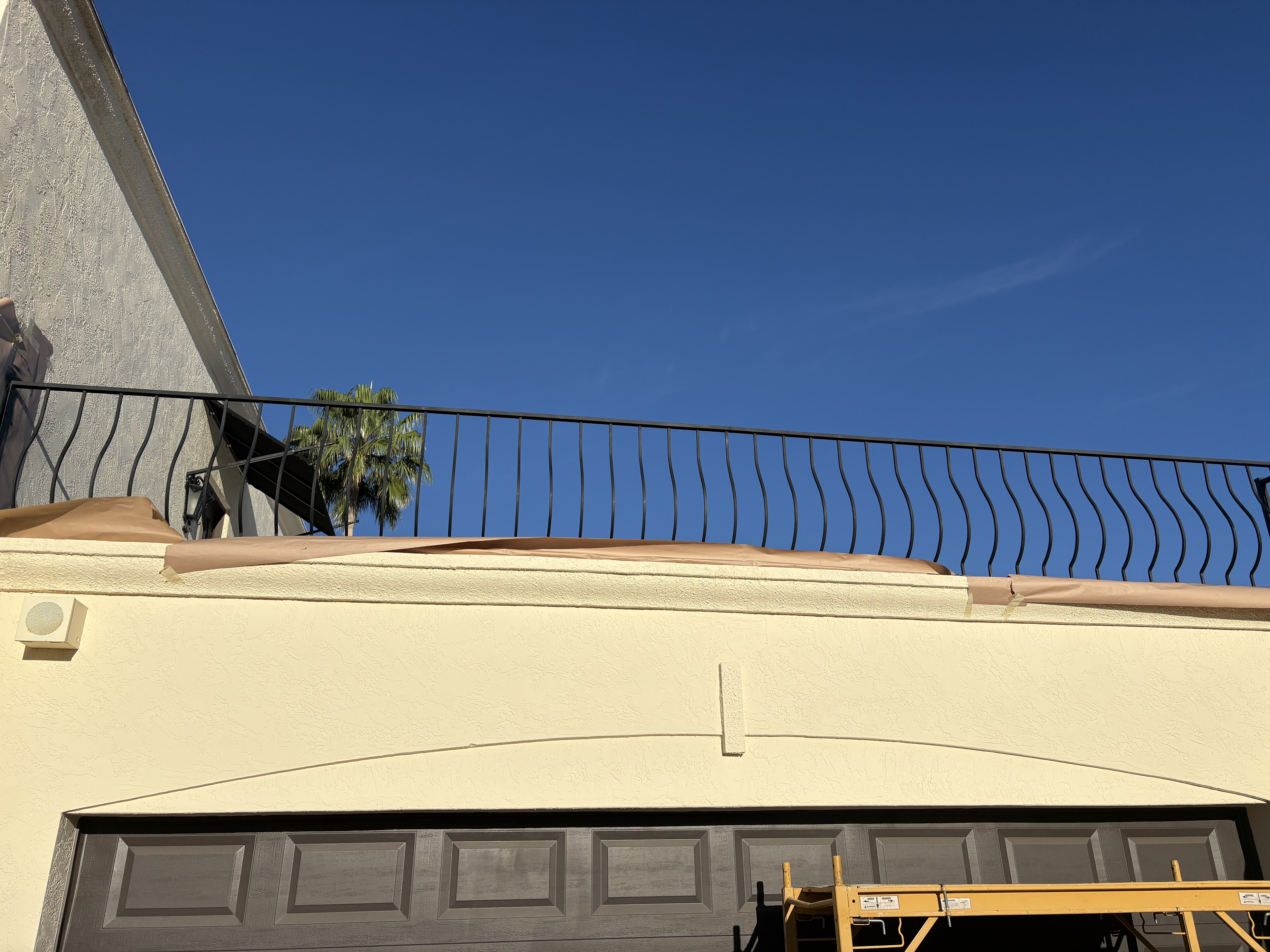 Iron railing installation on roofline balcony